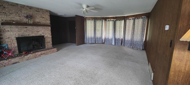 unfurnished living room with a ceiling fan, carpet, and a fireplace
