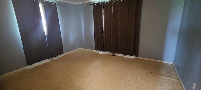 carpeted empty room with baseboards