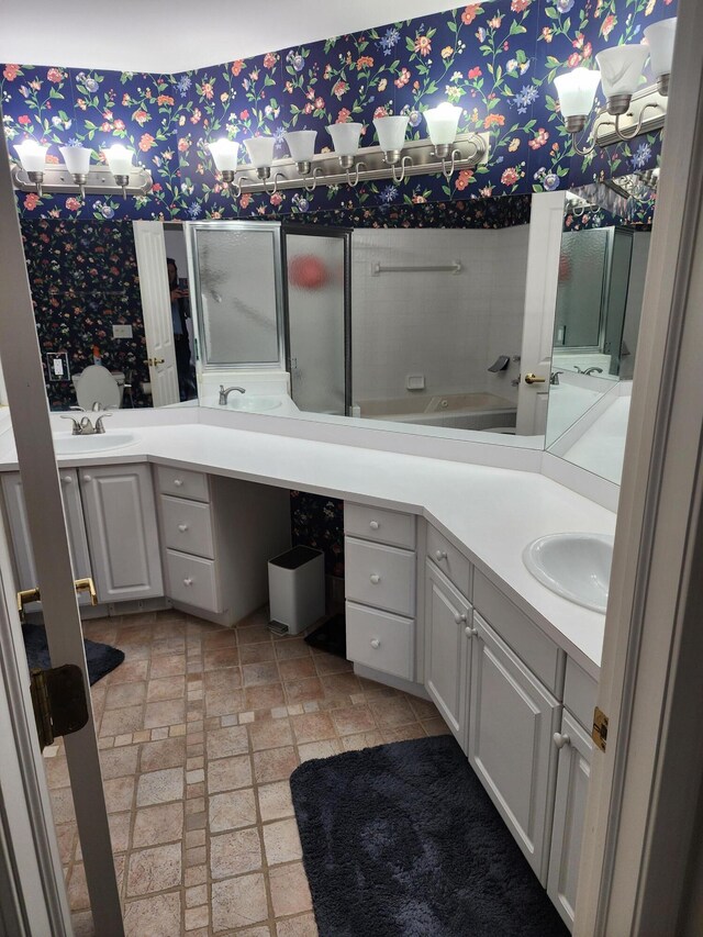 full bath featuring wallpapered walls, brick patterned floor, and vanity
