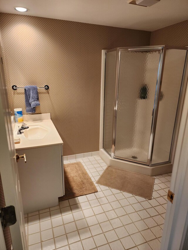 full bath featuring vanity, tile patterned floors, and a shower stall