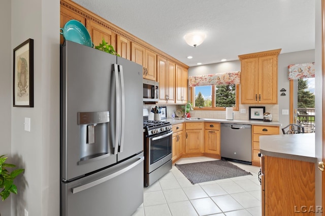 3136 Planeview Dr, Adrian, MI 49221 - kitchen featuring light countertops, stainless steel appliances, light tile patterned floors, and a sink
