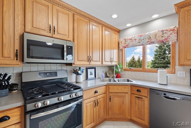 3136 Planeview Dr, Adrian, MI 49221 - kitchen with appliances with stainless steel finishes, a sink, light countertops, recessed lighting, and tasteful backsplash