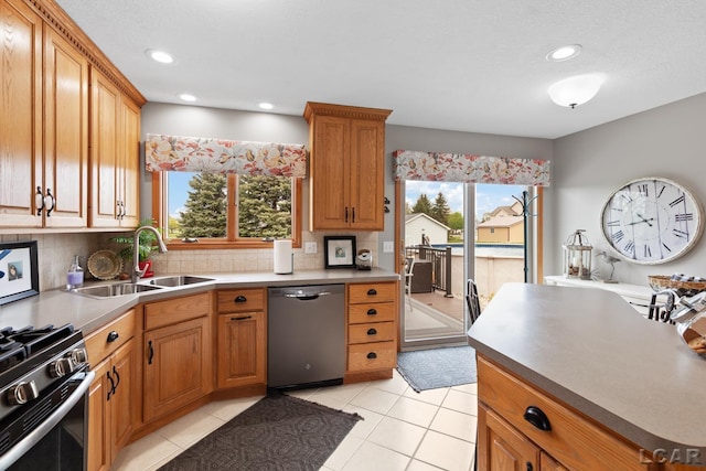 3136 Planeview Dr, Adrian, MI 49221 - kitchen with a sink, tasteful backsplash, a healthy amount of sunlight, and stainless steel appliances