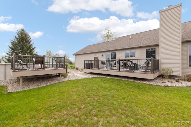 3136 Planeview Dr, Adrian, MI 49221 - rear view of house with a lawn, a shingled roof, a wooden deck, and a chimney