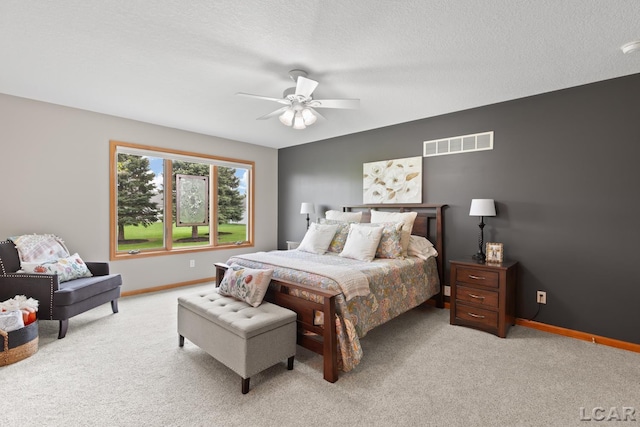 3136 Planeview Dr, Adrian, MI 49221 - bedroom featuring visible vents, baseboards, ceiling fan, light colored carpet, and a textured ceiling