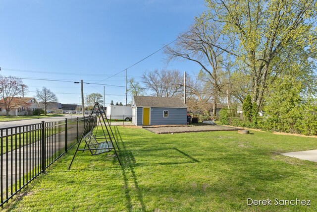view of yard featuring an outdoor structure and fence