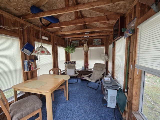 sunroom featuring carpet flooring and lofted ceiling