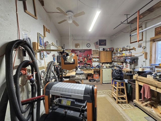 garage with ceiling fan and a workshop area