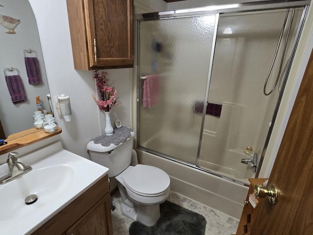 full bathroom featuring vanity, enclosed tub / shower combo, and toilet