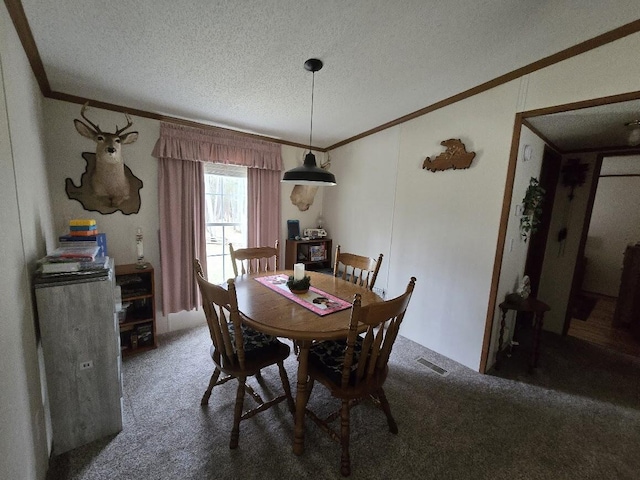 dining space featuring crown molding, carpet, a textured ceiling, and visible vents