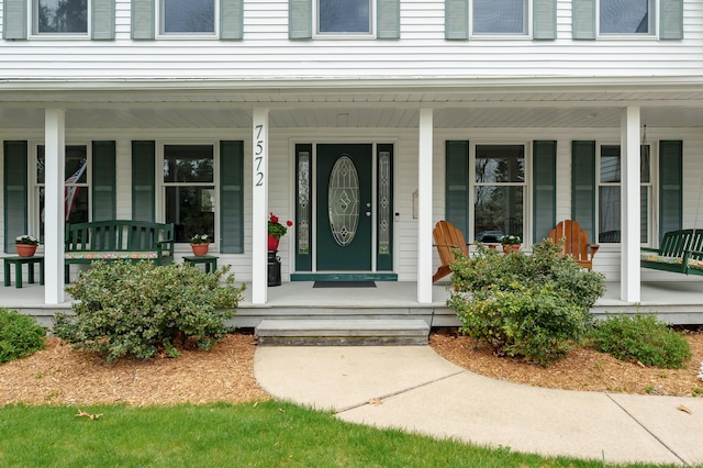 view of exterior entry with covered porch