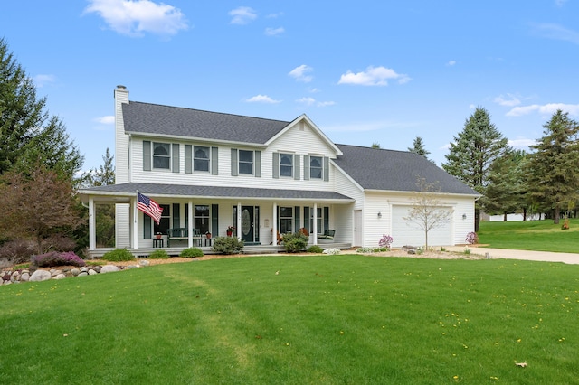 view of front of home with a front lawn, covered porch, a chimney, an attached garage, and driveway