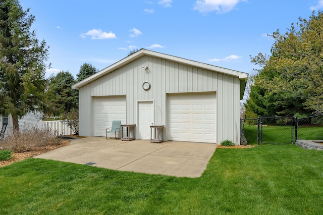 detached garage with a gate and fence