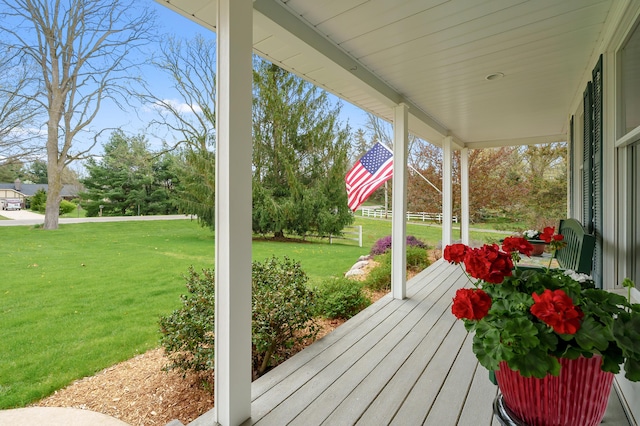 deck with a yard and a porch