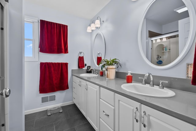 full bathroom with baseboards, visible vents, a sink, and tile patterned flooring