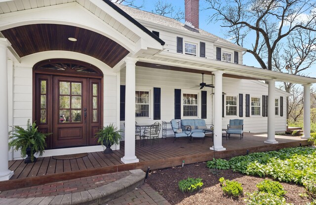 property entrance featuring covered porch and a chimney