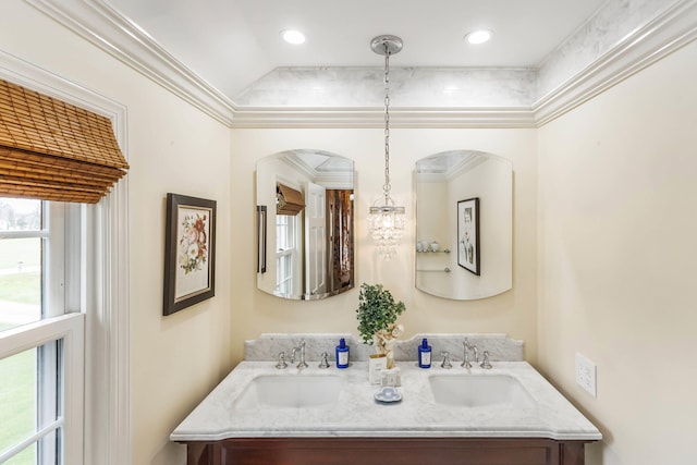 full bathroom featuring double vanity, ornamental molding, and a sink