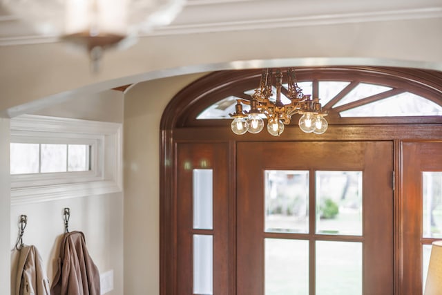 interior space featuring arched walkways and an inviting chandelier