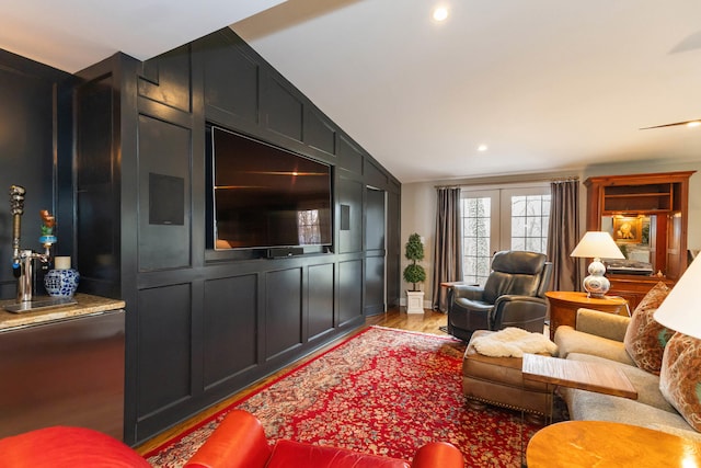 living area with light wood-type flooring, recessed lighting, and vaulted ceiling