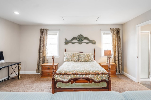 bedroom featuring carpet flooring, multiple windows, and attic access