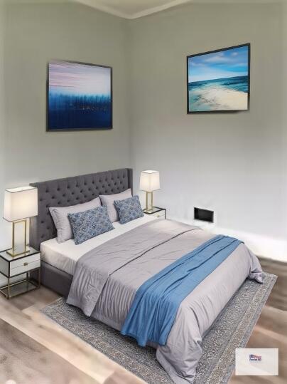 bedroom featuring crown molding and wood finished floors