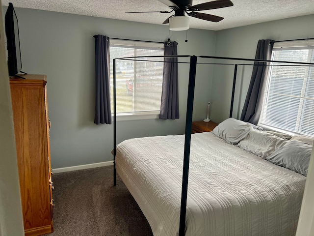 bedroom with baseboards, ceiling fan, carpet, and a textured ceiling