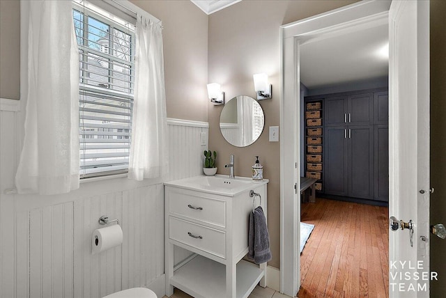 2630 Reeds Lake Ct SE, Grand Rapids, MI 49506 - bathroom featuring wainscoting, vanity, and wood finished floors
