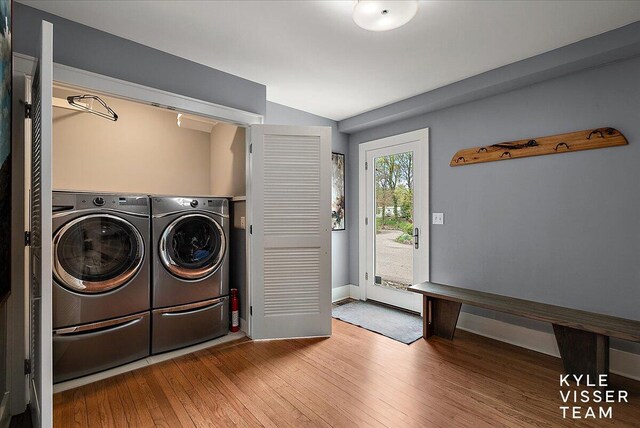 2630 Reeds Lake Ct SE, Grand Rapids, MI 49506 - laundry room featuring washing machine and clothes dryer, hardwood / wood-style floors, and baseboards