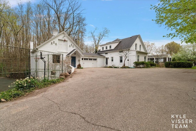 2630 Reeds Lake Ct SE, Grand Rapids, MI 49506 - view of front facade with driveway and a garage