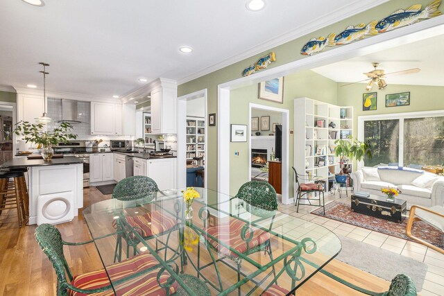 dining space featuring a ceiling fan, recessed lighting, and ornamental molding