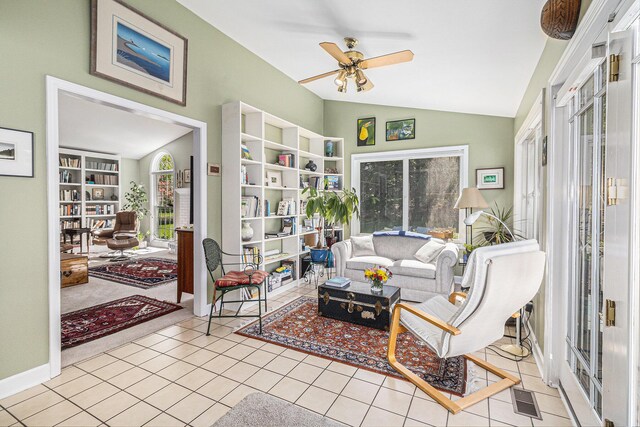 living area featuring plenty of natural light, a ceiling fan, lofted ceiling, and visible vents