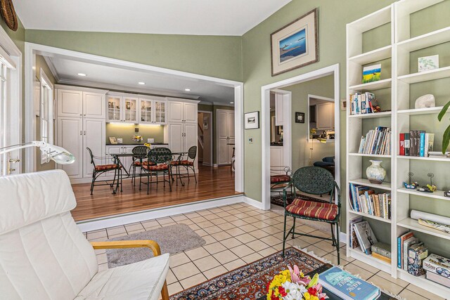living area featuring light tile patterned floors and lofted ceiling