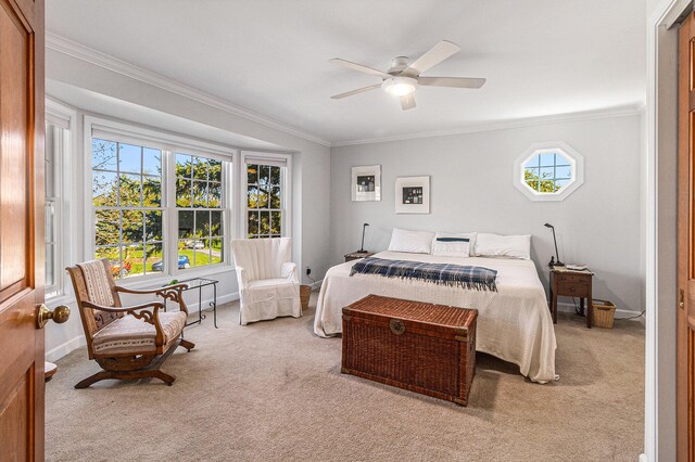 carpeted bedroom featuring crown molding, a ceiling fan, and baseboards
