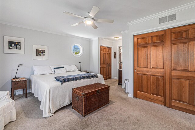 bedroom featuring ceiling fan, light colored carpet, crown molding, visible vents, and baseboards