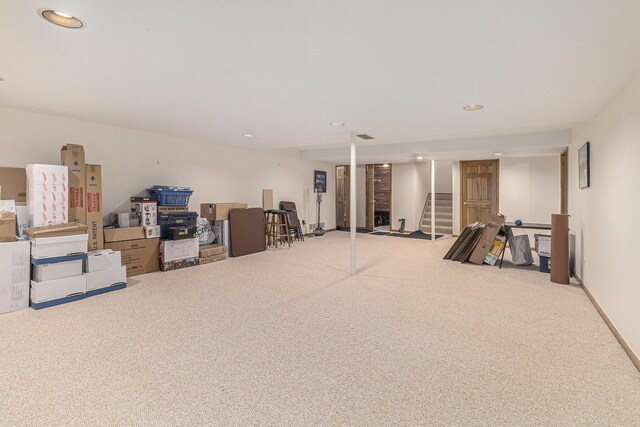 finished basement featuring stairway, carpet flooring, and recessed lighting