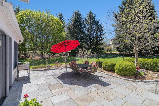 view of patio featuring fence and outdoor dining space
