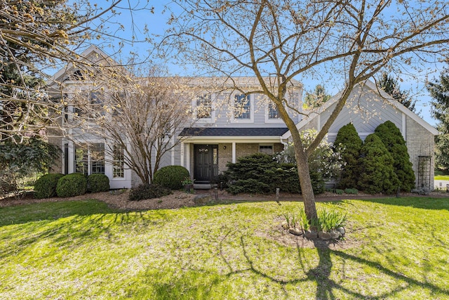 traditional home with brick siding and a front lawn