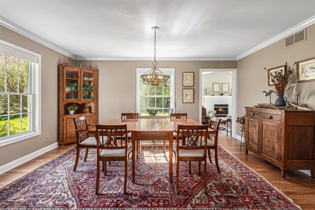 dining space with visible vents, plenty of natural light, and wood finished floors