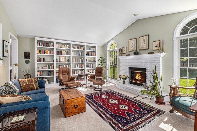 living room featuring carpet floors, lofted ceiling, and a fireplace