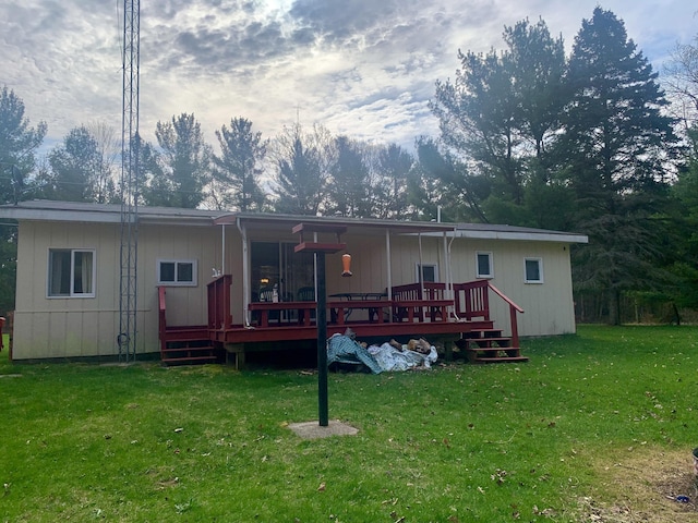 rear view of property with a lawn and a deck
