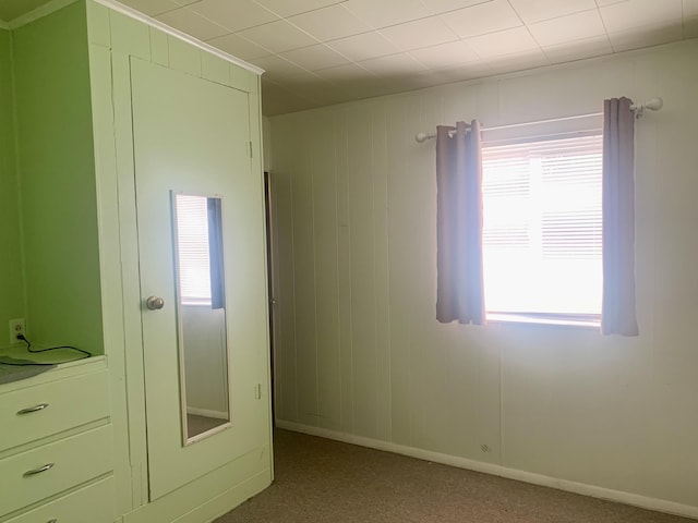 unfurnished bedroom with carpet floors and multiple windows