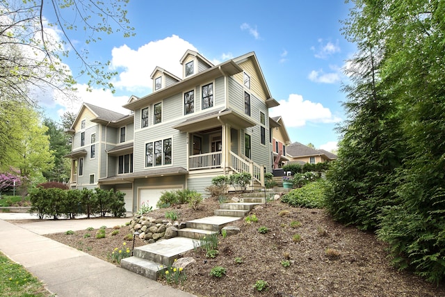 exterior space featuring an attached garage, covered porch, and concrete driveway