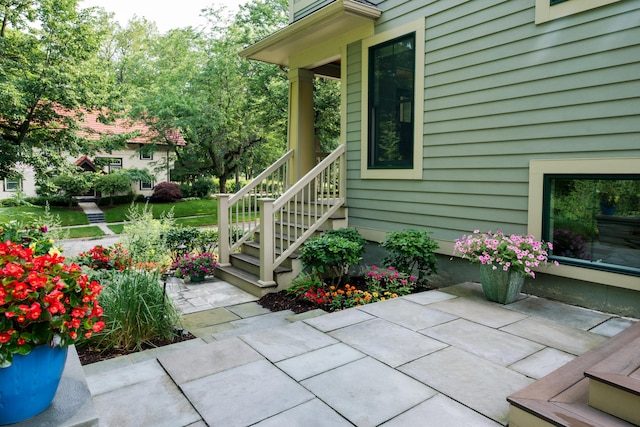 view of exterior entry with a patio