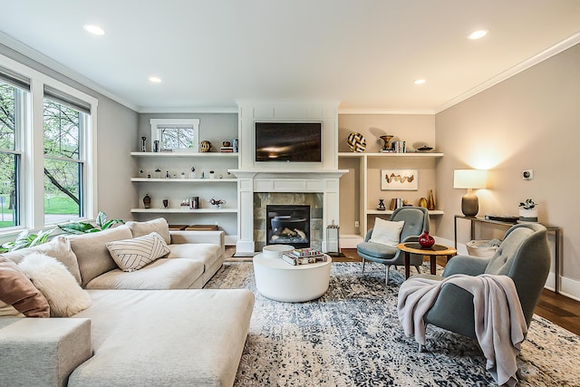 1614 Cambridge Rd, Ann Arbor, MI 48104 - living area with recessed lighting, ornamental molding, wood finished floors, and a tile fireplace