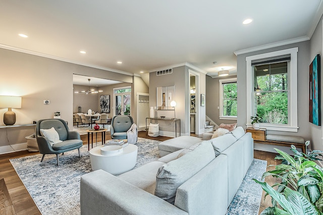 living area with visible vents, crown molding, stairway, baseboards, and dark wood-style floors