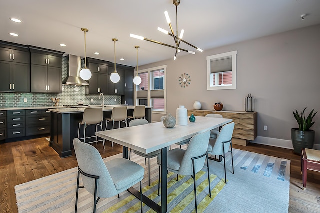 dining area with baseboards, recessed lighting, dark wood-style flooring, and a notable chandelier