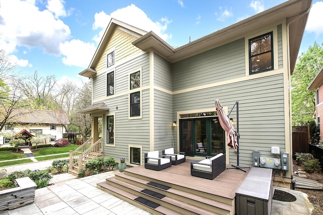 rear view of property featuring a patio area, french doors, and a deck