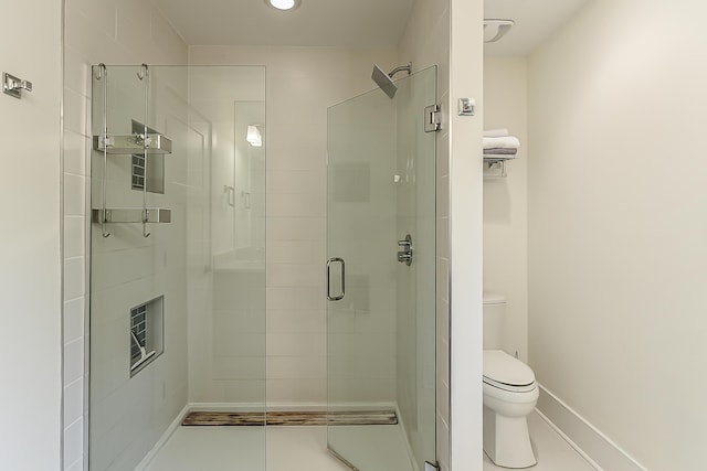 full bathroom with baseboards, tile patterned floors, a stall shower, and toilet