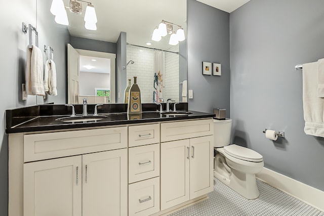 1614 Cambridge Rd, Ann Arbor, MI 48104 - full bath featuring a sink, tile patterned floors, toilet, and curtained shower