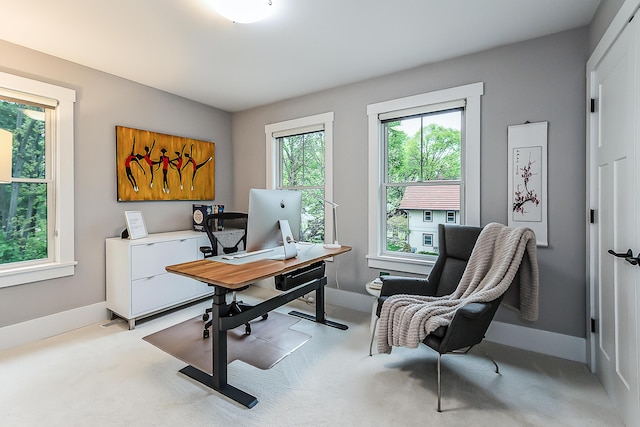 carpeted office featuring baseboards